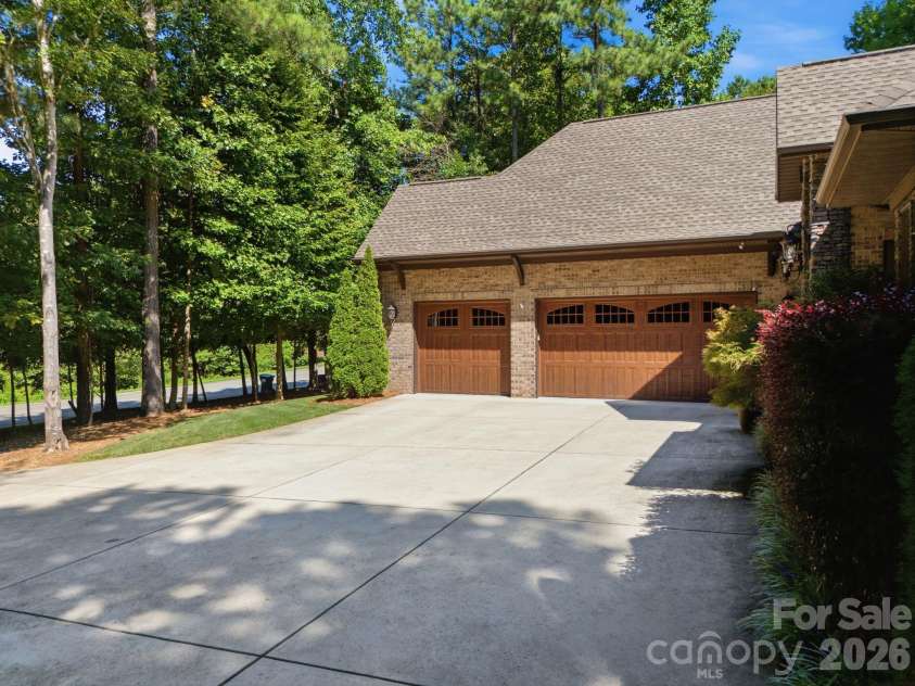 7197 Windy Ridge Drive, Iron Station, NC 28080.  MLS# CAR4417271, YatesRealty ID 48262. Three car courtyard garage