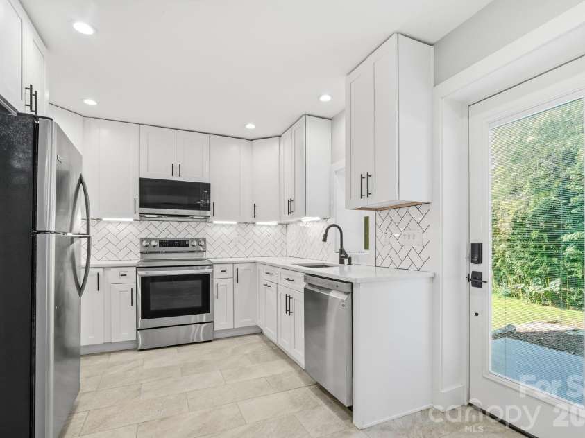 77 Trotter Place, Asheville, NC 28806.  MLS# CAR4419815, YatesRealty ID 48266. Lower Unit Kitchen and front door
