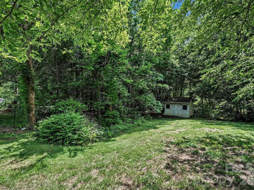9803 Cooper Run Lane, Charlotte, NC 28269.  MLS# CAR4419711, YatesRealty ID 48278. Nearly 1/2 Acre w/ Storage Shed