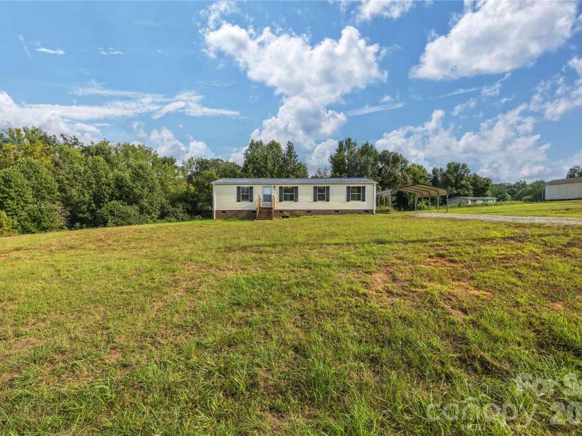 387 Haden Grove Church Road, Linwood, NC 27299.  MLS# CAR4420301, YatesRealty ID 48284. Large front yard