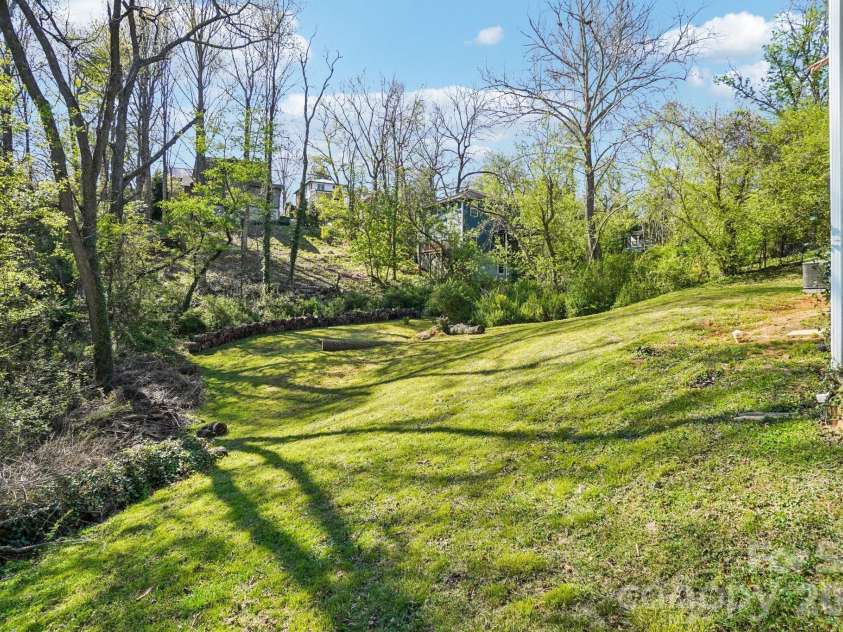 153 Hudson Street, Asheville, NC 28806.  MLS# CAR4420786, YatesRealty ID 48322. Back yard and front sideyard