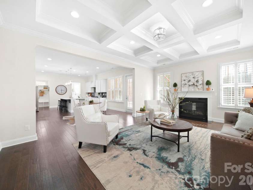 2185 Loire Valley Drive, Fort Mill, SC 29707.  MLS# CAR4353826, YatesRealty ID 4835. Stunning Open-Concept Great Room Featuring a Statement Coffered Ceiling, Cozy Fireplace, Abundant Natural Light, and a Seamless Flow into the Gourmet Kitchen and Breakfast Area