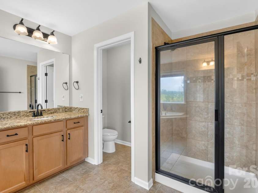 1004 Hawker Road, Matthews, NC 28104.  MLS# CAR4411741, YatesRealty ID 48396. Primary bathroom