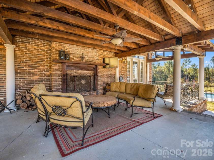 1102 Mountain Road, Bostic, NC 28018.  MLS# CAR4318780, YatesRealty ID 484. Back porch with wood burning fireplace