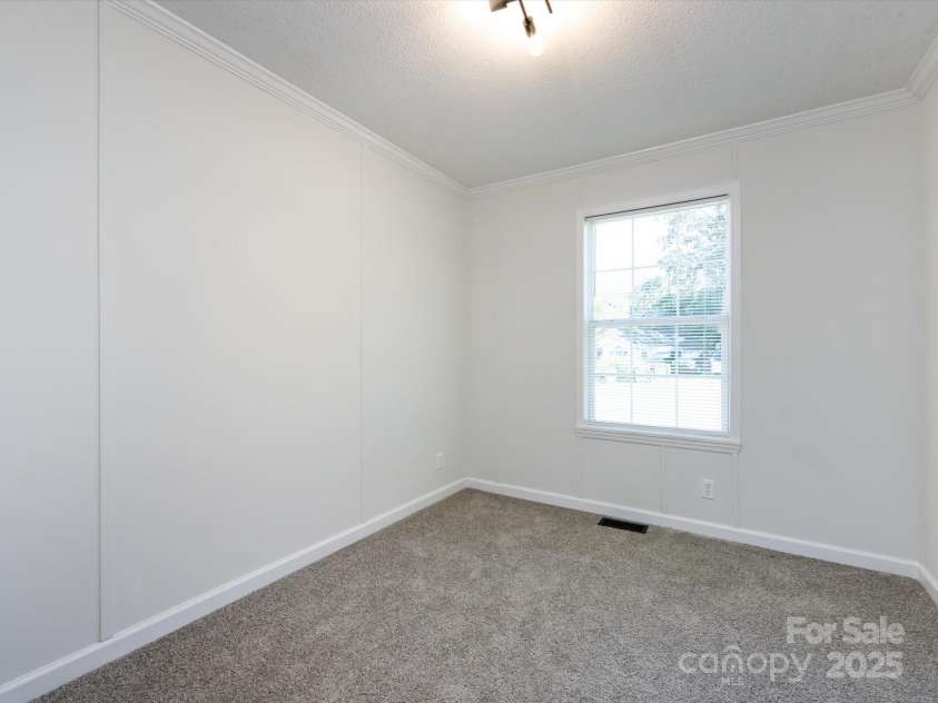 907 4th Avenue, Gastonia, NC 28054.  MLS# CAR4306590, YatesRealty ID 4842. Bedroom view with new carpet, farmhouse hardware, light fixture