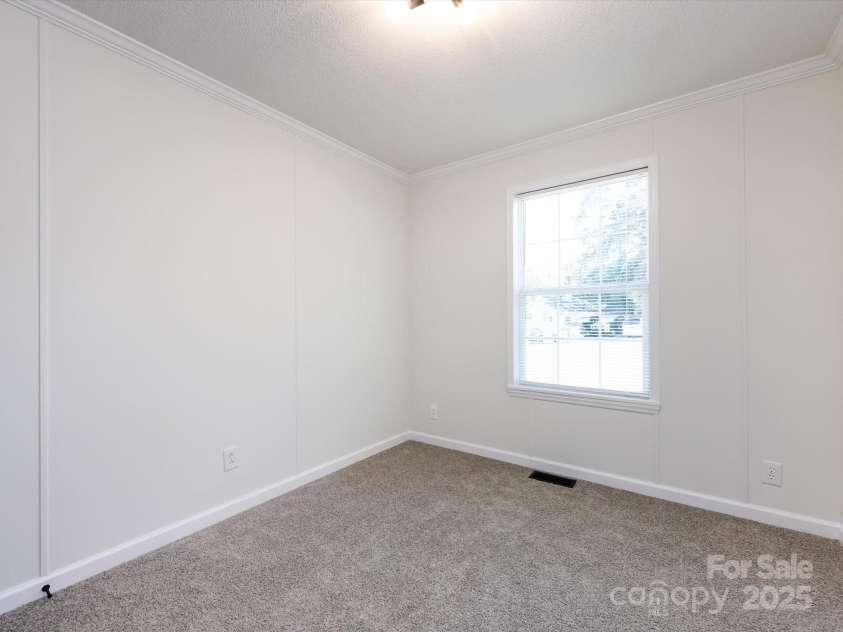 907 4th Avenue, Gastonia, NC 28054.  MLS# CAR4306590, YatesRealty ID 4842. Bedroom view with new carpet, farmhouse hardware, light fixture