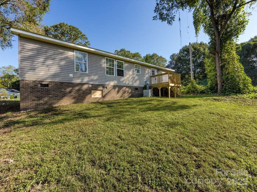 907 4th Avenue, Gastonia, NC 28054.  MLS# CAR4306590, YatesRealty ID 4842. Rear backyard view of home