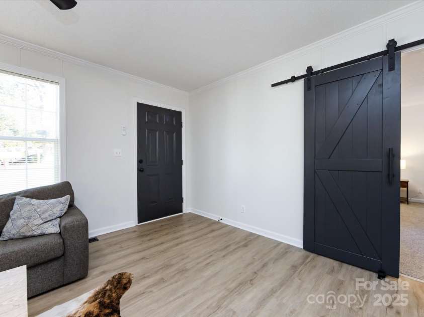 907 4th Avenue, Gastonia, NC 28054.  MLS# CAR4306590, YatesRealty ID 4842. View of entry on left and barn door to primary bedroom on right.