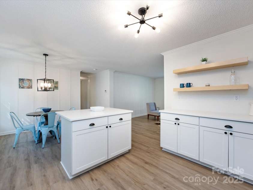 907 4th Avenue, Gastonia, NC 28054.  MLS# CAR4306590, YatesRealty ID 4842. View of kitchen looking out past island and family room on the right hand side. 