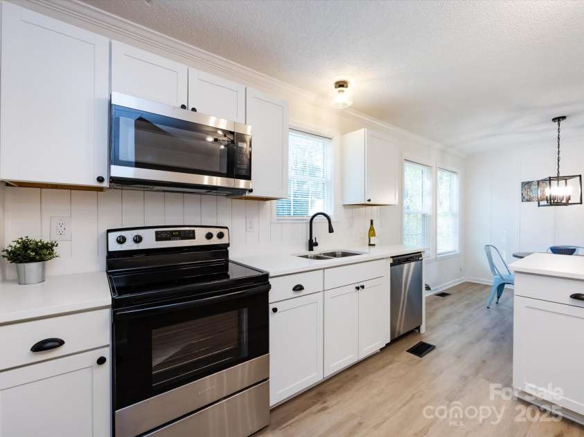 907 4th Avenue, Gastonia, NC 28054.  MLS# CAR4306590, YatesRealty ID 4842. View of kitchen with back to laundry room. 