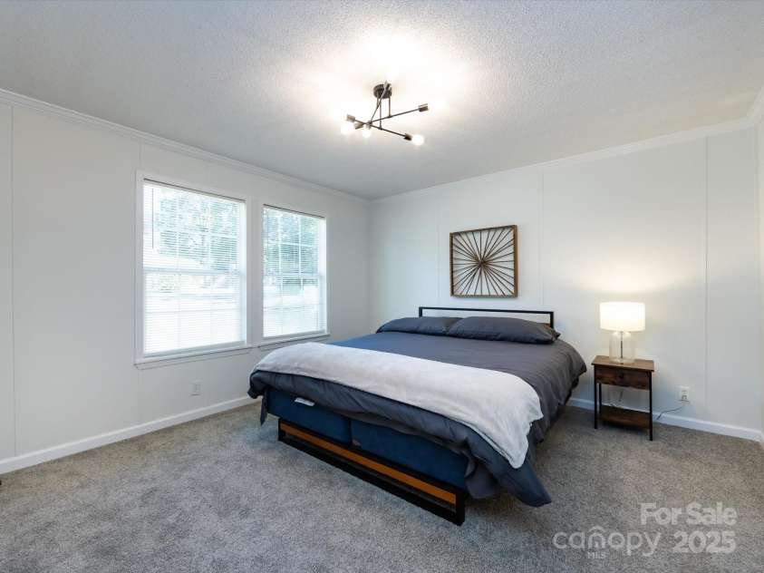 907 4th Avenue, Gastonia, NC 28054.  MLS# CAR4306590, YatesRealty ID 4842. View of primary bedroom with new carpet & light fixture. 