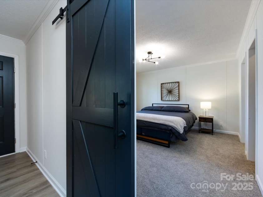907 4th Avenue, Gastonia, NC 28054.  MLS# CAR4306590, YatesRealty ID 4842. View of primary bedroom with nice barn door. 