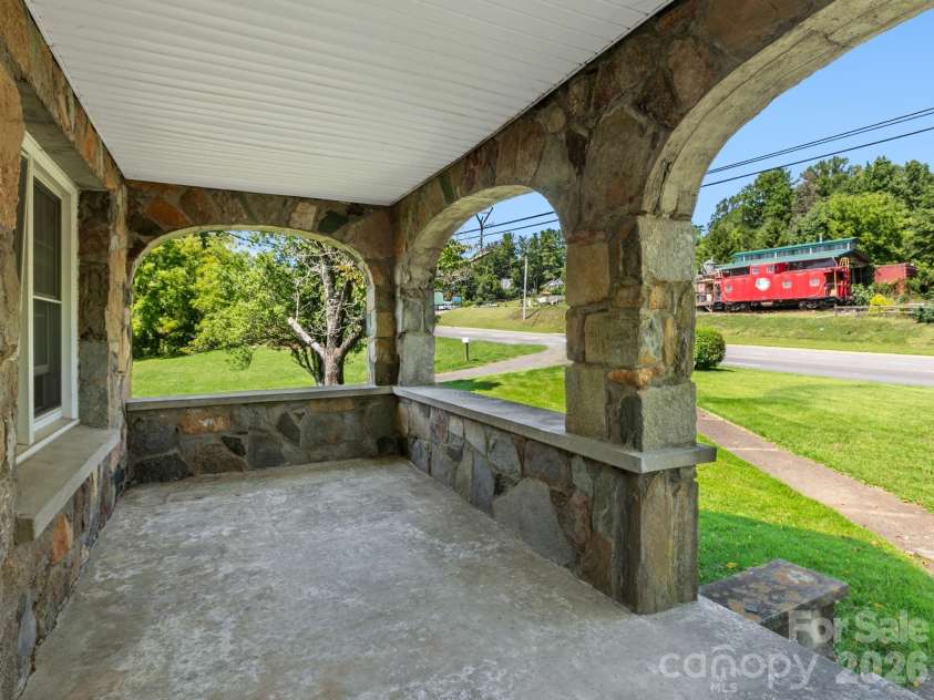 1279 Charlotte Highway, Fairview, NC 28730.  MLS# CAR4421024, YatesRealty ID 48430. Incredible Stoned Porch