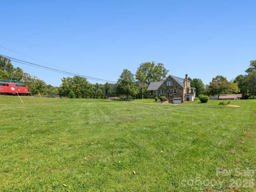 1279 Charlotte Highway, Fairview, NC 28730.  MLS# CAR4421024, YatesRealty ID 48430. Side yard