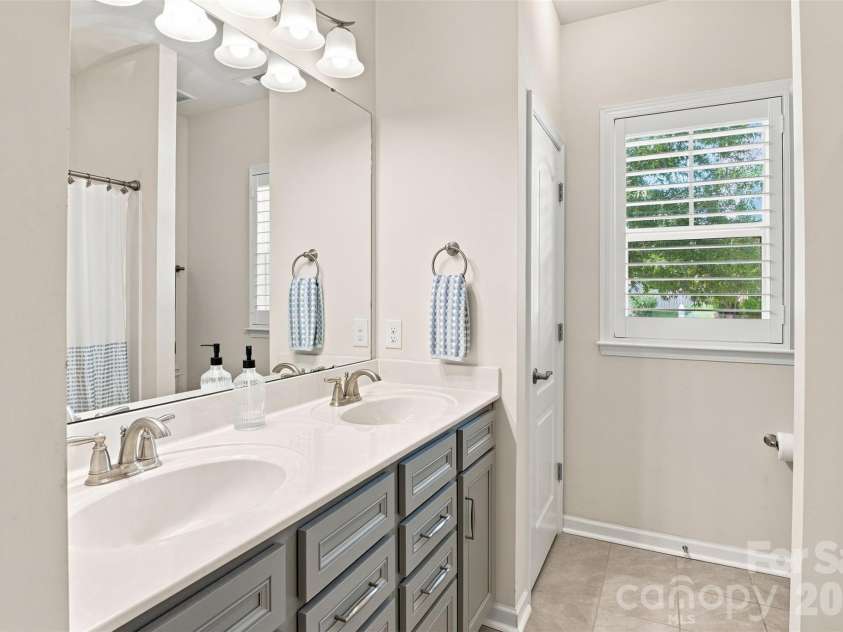 15704 Reynolds Drive, Indian Land, SC 29707.  MLS# CAR4419421, YatesRealty ID 48457. Full secondary bathroom with dual vanity