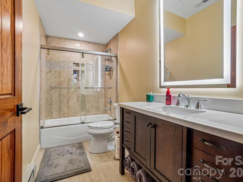 1067 English Ridge Drive, Mars Hill, NC 28754.  MLS# CAR4409023, YatesRealty ID 48493. Guest Bathroom Lower Level