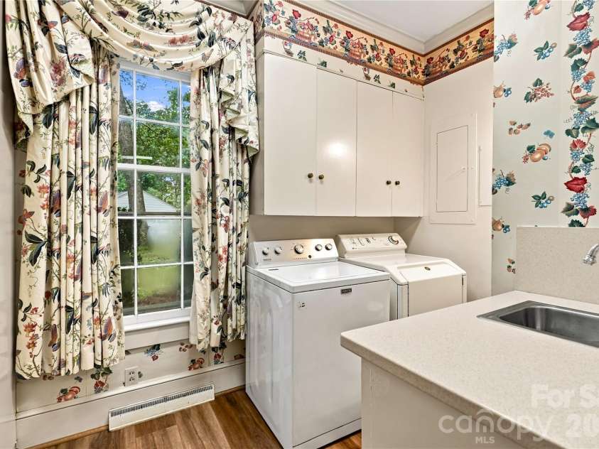 209 Labans Lane, Lincolnton, NC 28092.  MLS# CAR4419321, YatesRealty ID 48497. Main-level laundry room with cabinetry, sink and half bath.