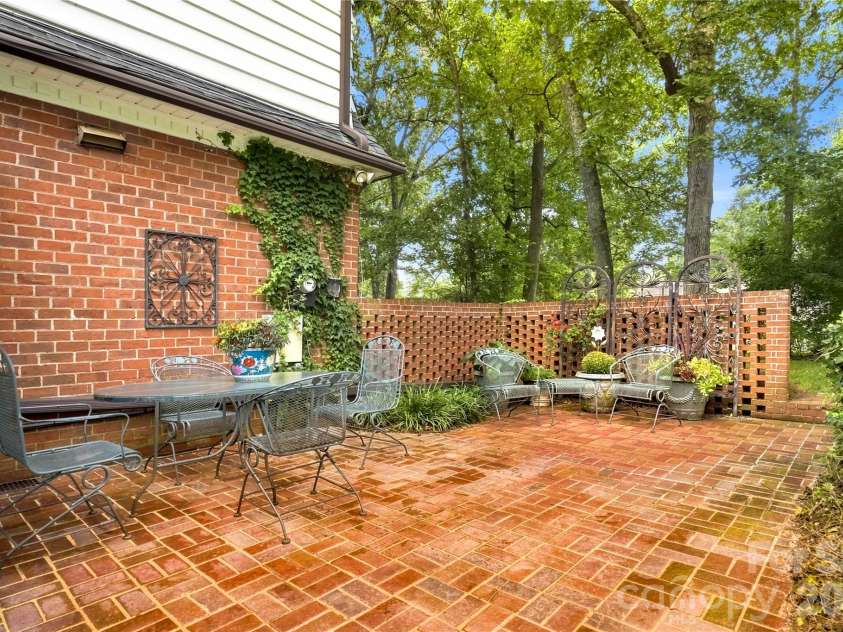 209 Labans Lane, Lincolnton, NC 28092.  MLS# CAR4419321, YatesRealty ID 48497. Private brick patio surrounded by established landscaping.