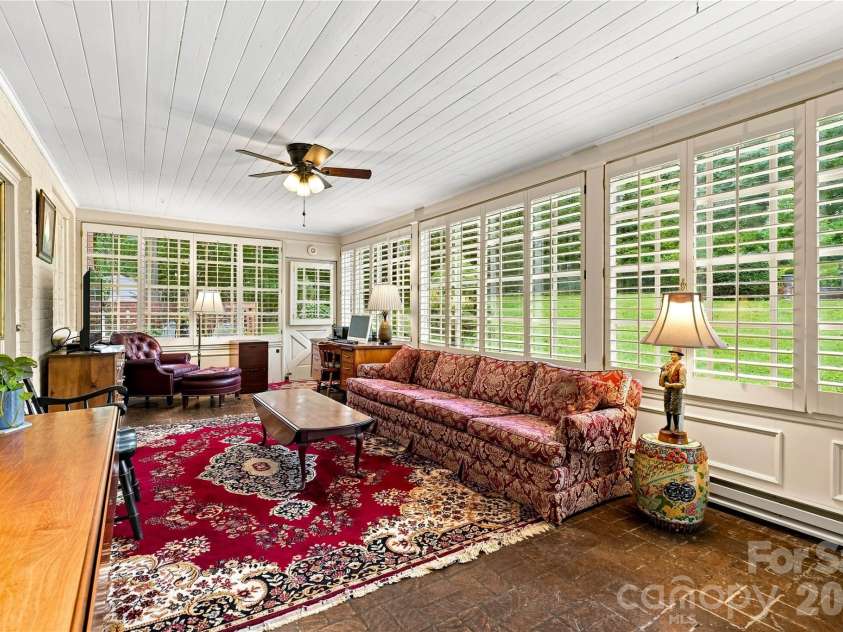 209 Labans Lane, Lincolnton, NC 28092.  MLS# CAR4419321, YatesRealty ID 48497. Sunroom surrounded by windows and plantation shutters.