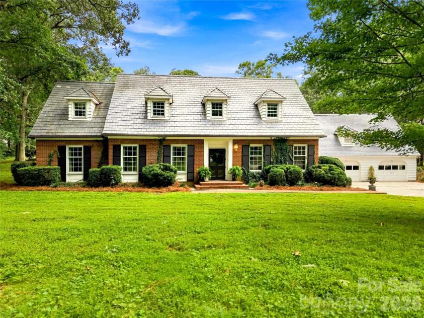 209 Labans Lane, Lincolnton, NC 28092.  MLS# CAR4419321, YatesRealty ID 48497. Williamsburg-style home framed by mature trees and established landscaping.