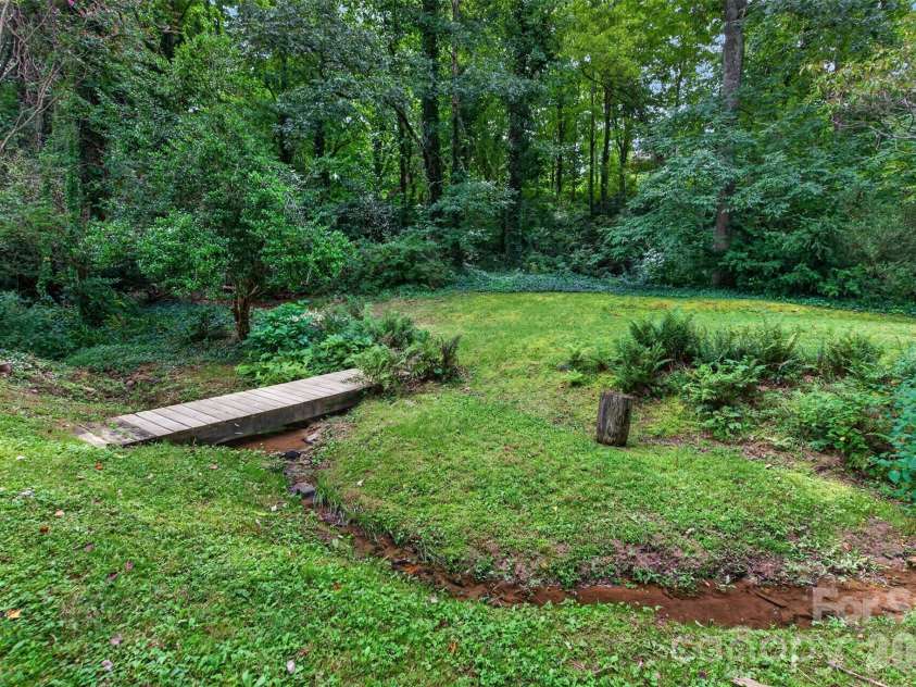 7 Mountainbrook Road, Asheville, NC 28805.  MLS# CAR4418468, YatesRealty ID 48585. Stream Running Through Back Yard