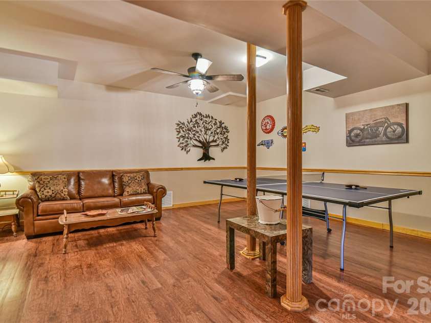 27 Winn Drive, Leicester, NC 28748.  MLS# CAR4419621, YatesRealty ID 48643. Lower level rec room; potential home theater.