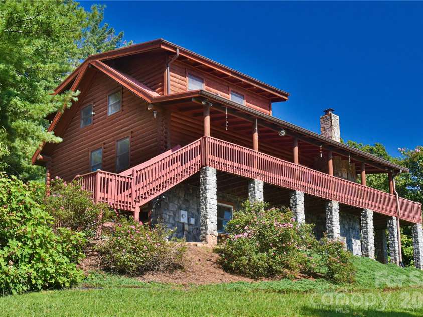 27 Winn Drive, Leicester, NC 28748.  MLS# CAR4419621, YatesRealty ID 48643. This log home looks stately and solid on this ridge. Wait until you access that wrap around porch and see the views!