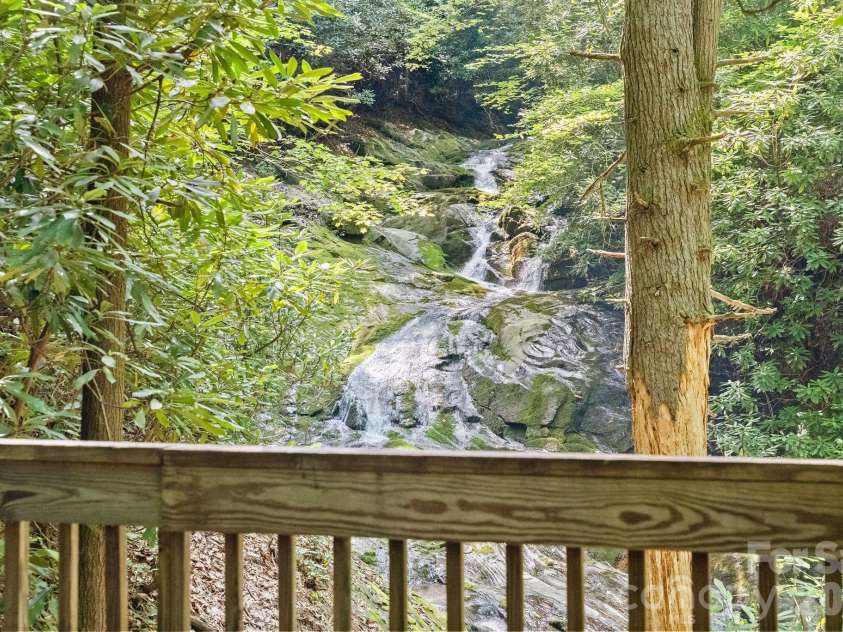 1915 Creston Drive, Black Mountain, NC 28711.  MLS# CAR4402197, YatesRealty ID 48644. Enjoy a picnic on the deck overlooking the private waterfall