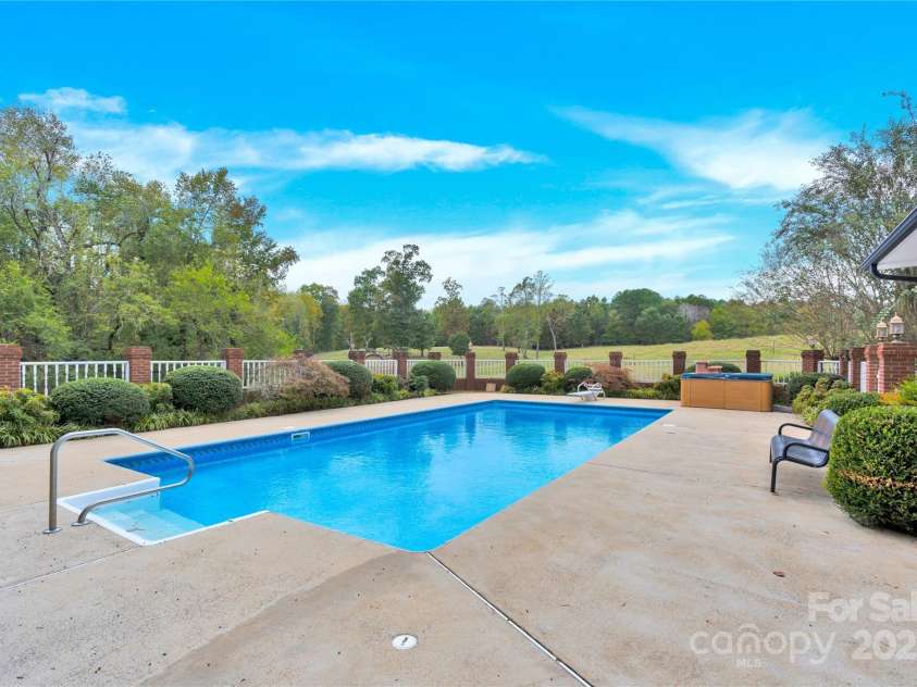 11720 Kluttz Road, Gold Hill, NC 28071.  MLS# CAR4310441, YatesRealty ID 4865. In-ground salt water pool with gated surround