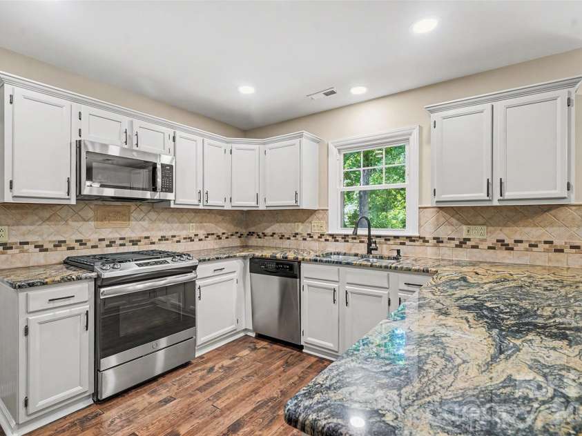 6443 High Creek Court, Charlotte, NC 28277.  MLS# CAR4420225, YatesRealty ID 48657. Kitchen with white cabinetry and granite counters