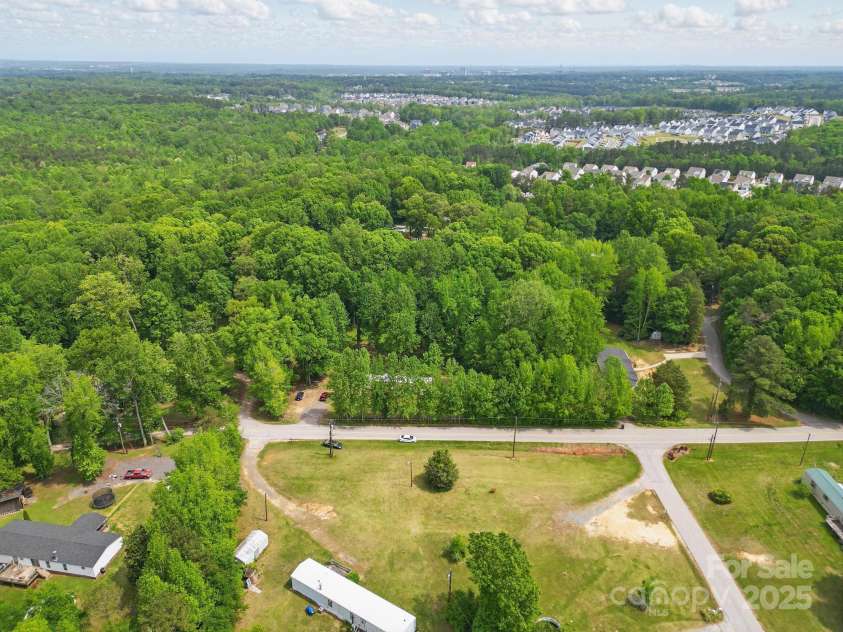 10420 Silver Mine Road, Indian Land, SC 29707.  MLS# CAR4251908, YatesRealty ID 4870. Aerial view of tree line view of the front of subject yard