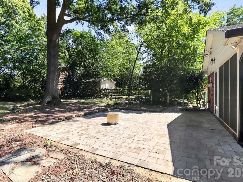 831 Faircrest Drive, Charlotte, NC 28210.  MLS# CAR4421440, YatesRealty ID 48734. Custom paver patio extends your outdoor entertaining space