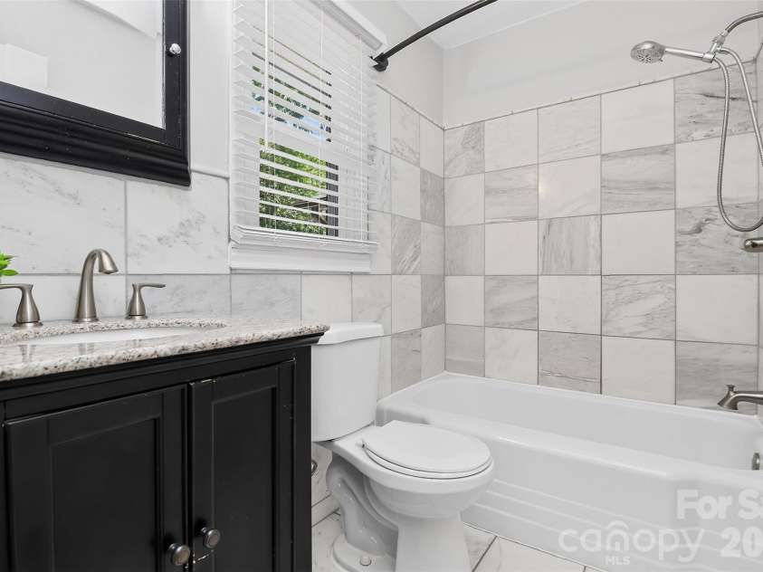 831 Faircrest Drive, Charlotte, NC 28210.  MLS# CAR4421440, YatesRealty ID 48734. Primary bath features marble tile over tub