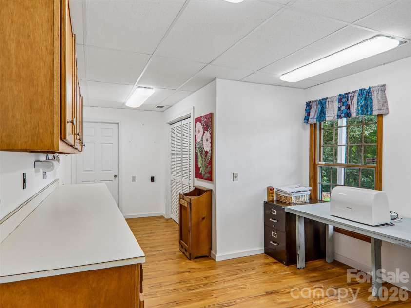 16 Hobe Crest, Hendersonville, NC 28792.  MLS# CAR4420313, YatesRealty ID 48745. Hobby/ craft room with extra storage and work space.