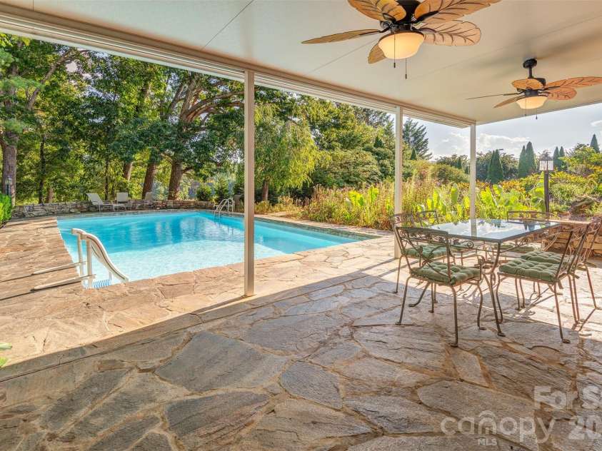 64 Greenridge Road, Weaverville, NC 28787.  MLS# CAR4420101, YatesRealty ID 48748. Lower level covered porch and access to pool