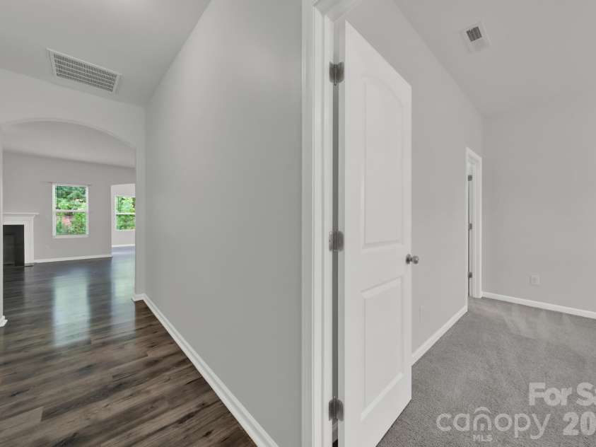 5121 Saddleback Drive, Mount Holly, NC 28120.  MLS# CAR4421137, YatesRealty ID 48763. Foyer and primary bedroom