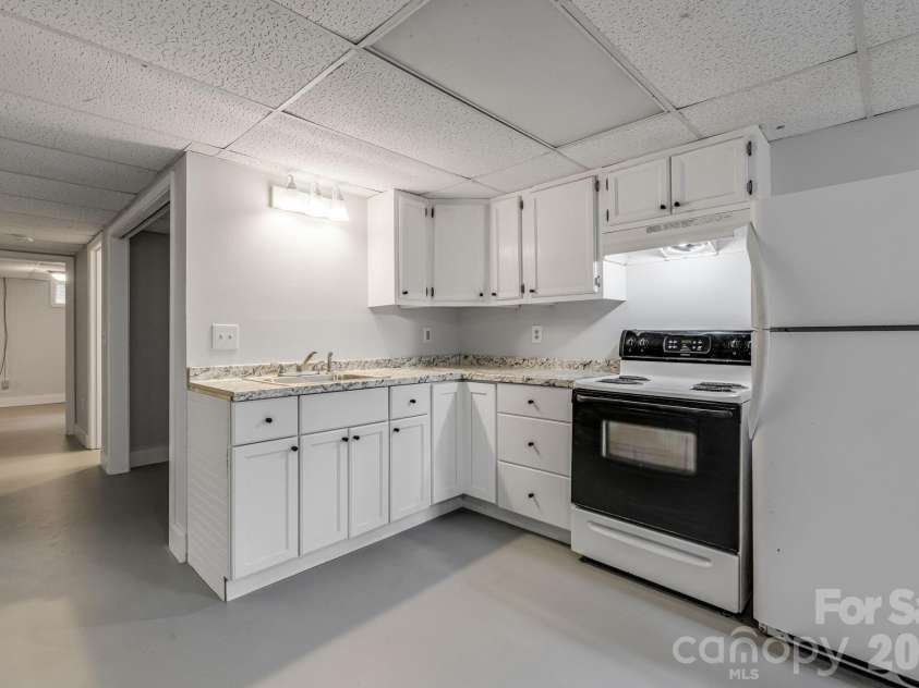 25 Hickory Tree Road, Asheville, NC 28805.  MLS# CAR4418920, YatesRealty ID 48783. Basement kitchen