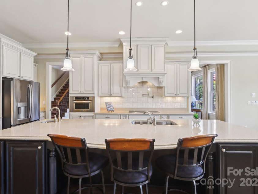 1322 Shinnecock Lane, Fort Mill, SC 29707.  MLS# CAR4239031, YatesRealty ID 4879. Double ovens, microwave, solid surface range w/ pot filler (plumbed for gas cooktop as well) & exterior vented hood.