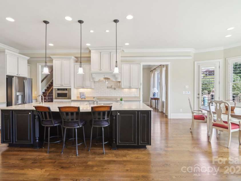 1322 Shinnecock Lane, Fort Mill, SC 29707.  MLS# CAR4239031, YatesRealty ID 4879. Herringbone subway tile backsplash, under counter & recessed lighting. Pantry w/ solid surface wood shelving.