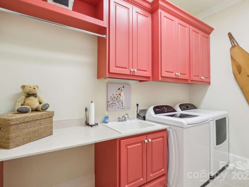 1322 Shinnecock Lane, Fort Mill, SC 29707.  MLS# CAR4239031, YatesRealty ID 4879. Large laundry w/ ample cabinetry, hanging rack, utility sink & tile floors.