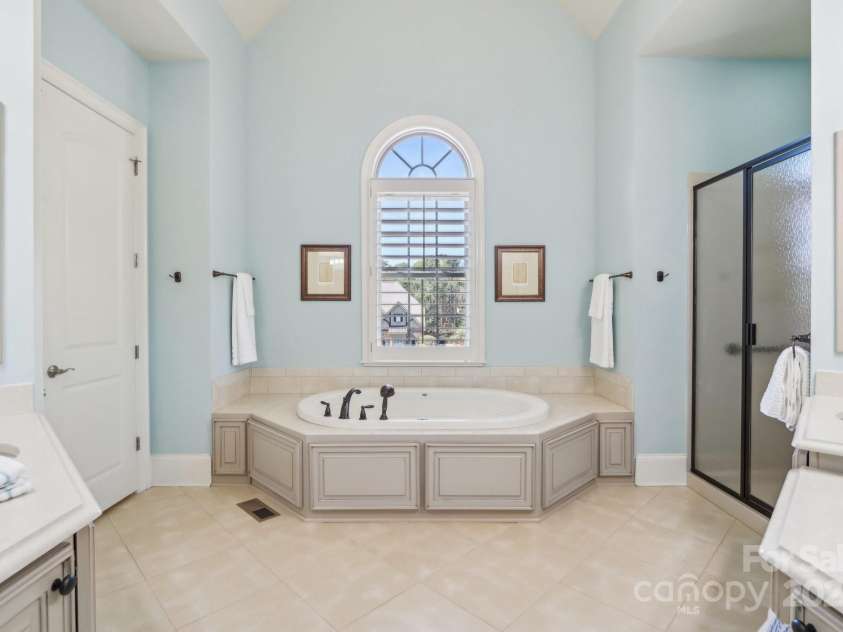 1322 Shinnecock Lane, Fort Mill, SC 29707.  MLS# CAR4239031, YatesRealty ID 4879. Primary bathroom w/ dramatic vaulted ceiling. Jacuzzi tub w/ tile surround, seperate raised vanities w/ quartz counters, linen closet, large walk in shower & water closet.