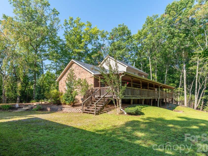 1886 Tanasee Gap Road, Balsam Grove, NC 28708.  MLS# CAR4421630, YatesRealty ID 48802. Back covered porch