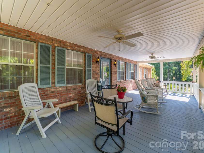 1886 Tanasee Gap Road, Balsam Grove, NC 28708.  MLS# CAR4421630, YatesRealty ID 48802. Front covered porch with fan for relaxing days