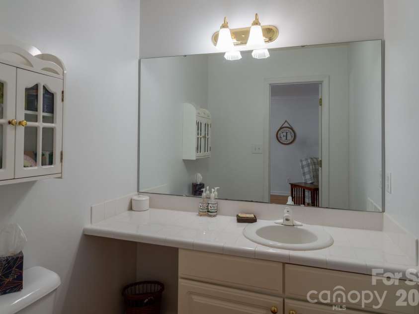 1886 Tanasee Gap Road, Balsam Grove, NC 28708.  MLS# CAR4421630, YatesRealty ID 48802. Half bath just outside kitchen area