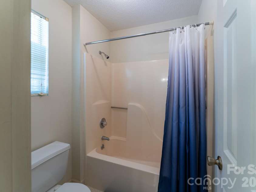 1886 Tanasee Gap Road, Balsam Grove, NC 28708.  MLS# CAR4421630, YatesRealty ID 48802. They share a full bathroom. The tub & commode are separate from the sink area.