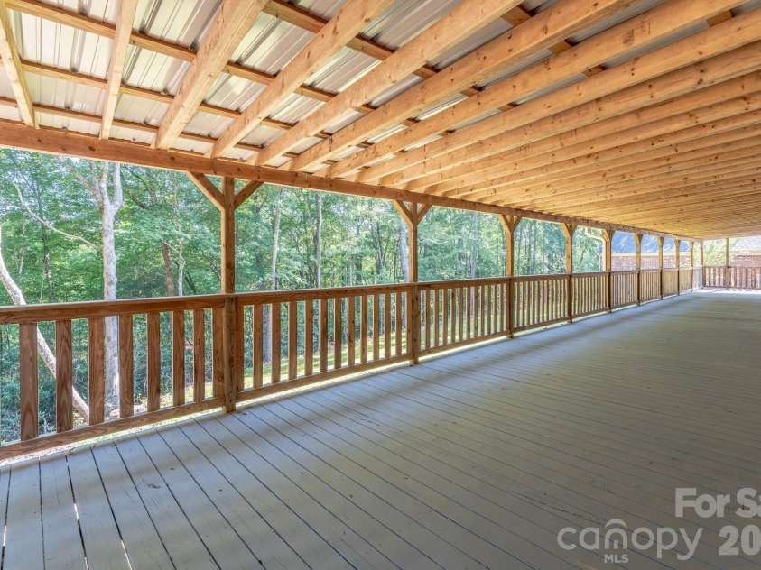 1886 Tanasee Gap Road, Balsam Grove, NC 28708.  MLS# CAR4421630, YatesRealty ID 48802. View from other side of back porch