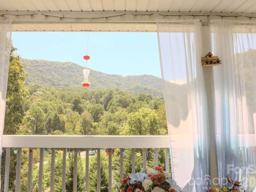 76 Patriot Drive, Waynesville, NC 28786.  MLS# CAR4418358, YatesRealty ID 48836. Deck View at Midday