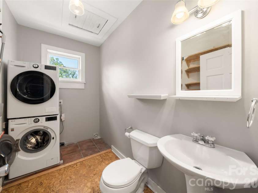 101 Olney Road, Asheville, NC 28806.  MLS# CAR4421259, YatesRealty ID 48879. Laundry/half bath combination with attic storage space above