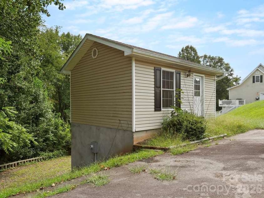 66 Azalea Drive, Weaverville, NC 28787.  MLS# CAR4421280, YatesRealty ID 48881. Detached two level workshop/storage with separate parking.