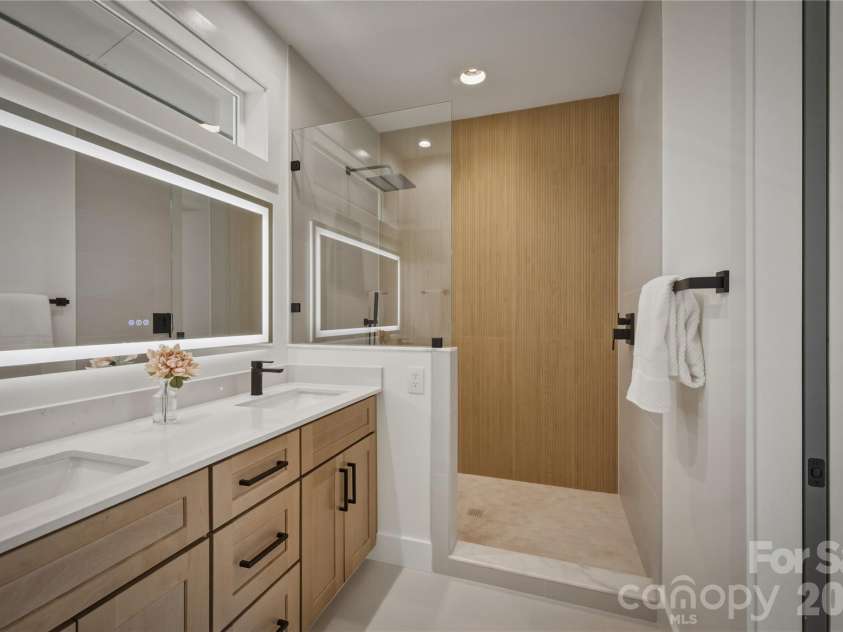 2303 Paddock Circle, Morganton, NC 28655.  MLS# CAR4416605, YatesRealty ID 48902. This bathroom has double sinks, a nice sized vanity, and a lighted mirror.
